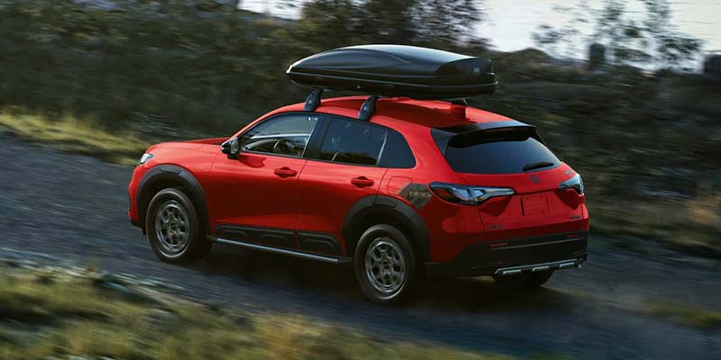 2026 Honda HR-V in red with roof box for extra cargo.